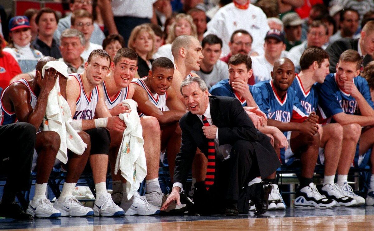 Star Roy Williams congratulates his players after the Jayhawks pounded Iowa State and he cleared his bench. at the 1997 Big 12 tournament.
