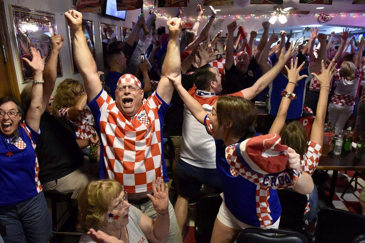 Hundreds of Croatian soccer fans crammed into two floors of St. John Catholic Club to watch Croatia play Russia during the 2018 World Cup. The crowd, including Mike Mikesic of Basehor (the one with the painted head), daughter Michayla Mikesic, right, and mother Paula Mikesic, seated, erupted after Croatia beat Russia on penalty kicks. 