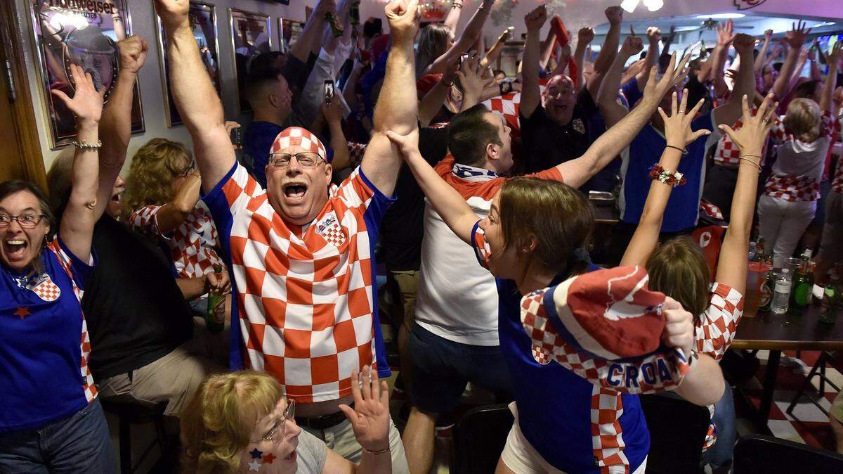 Hundreds of Croatian soccer fans crammed into two floors of St. John Catholic Club to watch Croatia play Russia during the 2018 World Cup. The crowd, including Mike Mikesic of Basehor (the one with the painted head), daughter Michayla Mikesic, right, and mother Paula Mikesic, seated, erupted after Croatia beat Russia on penalty kicks.