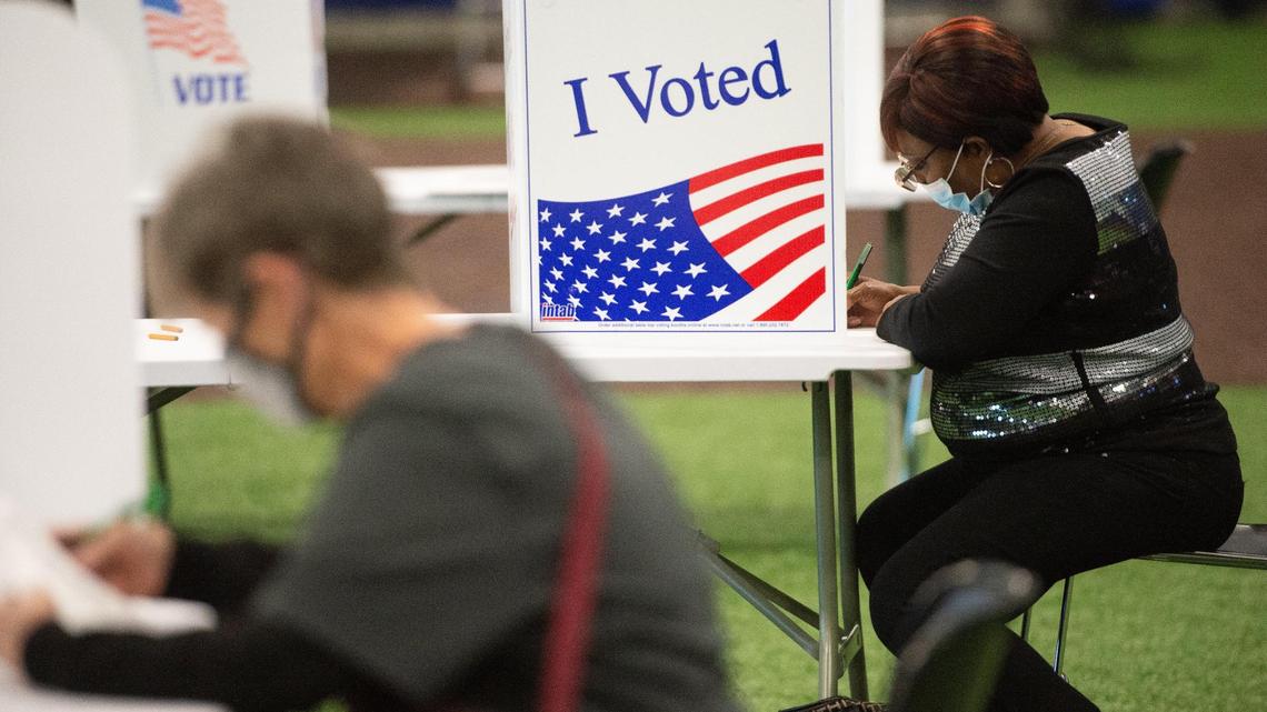 Bernice Johnson, right, votes on her paper ballot at the Kansas City Urban Youth Academy Tuesday, Nov. 3, 2020.