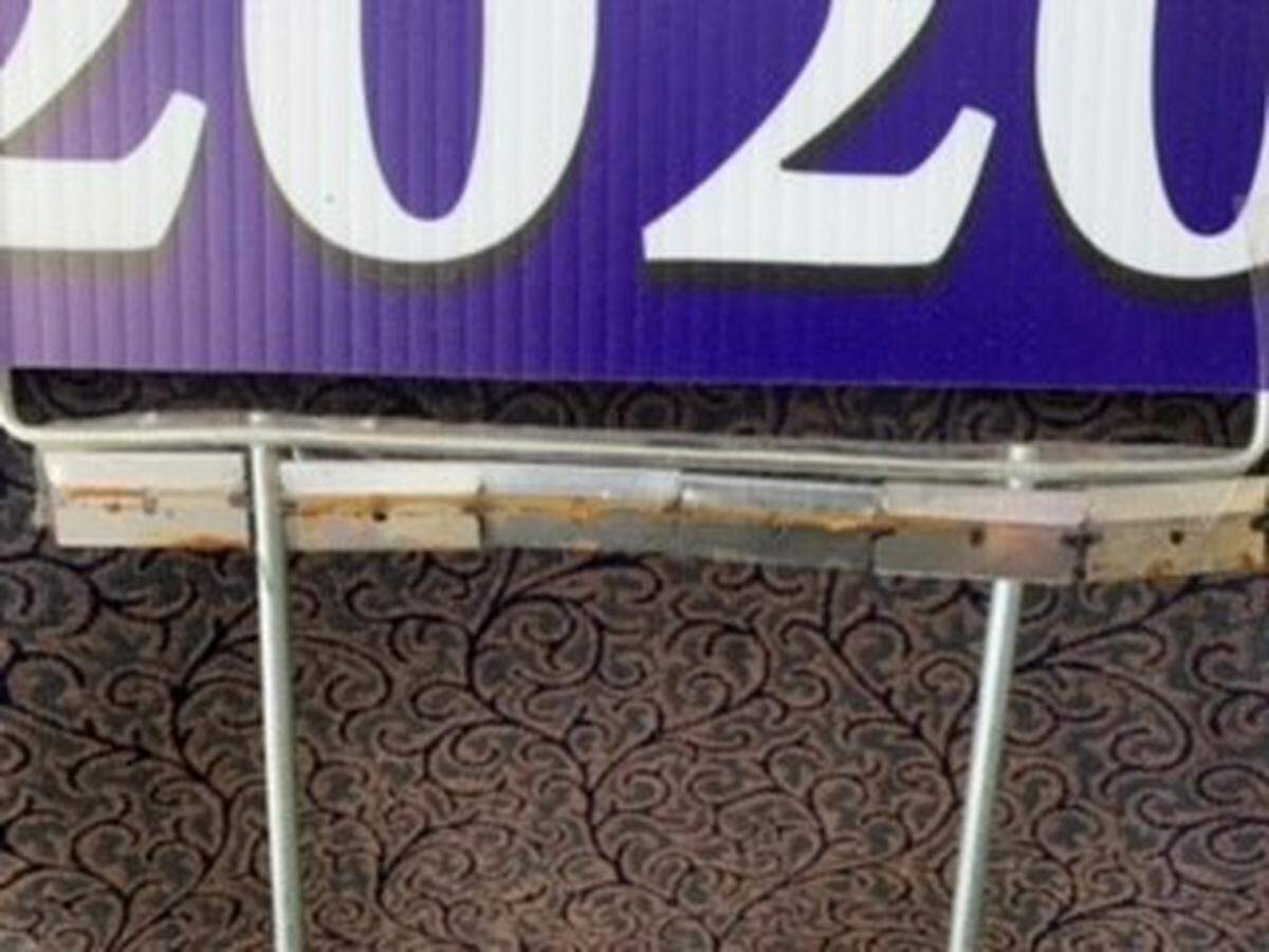 Michigan officials say a township worker was injured while trying to remove a Trump-Pence political sign that was lined with razor blades.