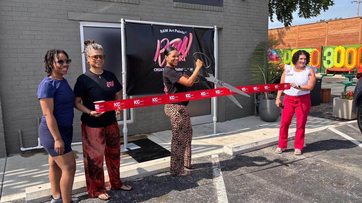 Remy Wharry cuts the ribbon outside her new Raw Art Studio during a soft opening celebration through Kansas City’s Open Doors program. The studio will offer art workshops, retail, paint kits and community-focused creative programming.
