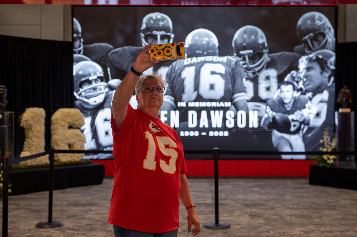 Kansas City Chiefs fan Verlee Gilkerson takes a moment to snap a photo of herself at the Len Dawson memorial tribute on Thursday, Sep. 1, 2022 at Arrowhead Stadium.
