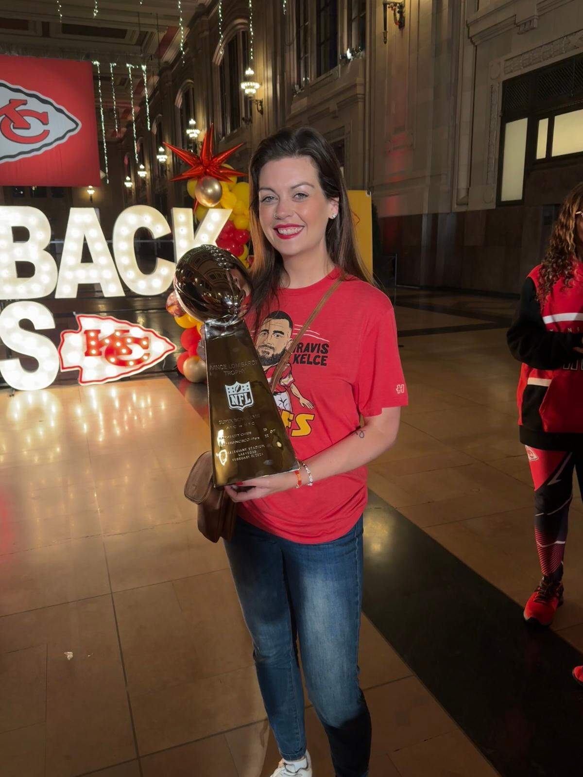 Jordan Johnson, aka @SwiftieinKC, holding a replica of the Chiefs’ Super Bowl trophy at Union Station.