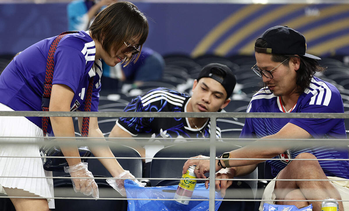 Japanese fans cleaned the stands after the match between Japan and Sweden on June 25.