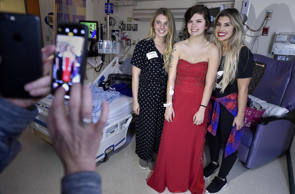 Children's Mercy Hospital held its first prom - red carpet and all - Friday, April 13, 2018. Seventeen-year-old Taylor Scott of Holden, Mo., (center) poses for a photo with Olivia Diehl (left) and Emmy Fernandes (right). Diehl, who is with Sporting Kansas City, did Taylor's makeup and Fernandes, who did Taylor's hair, is the wife of Sporting Kansas City player Gerso Fernandes.
