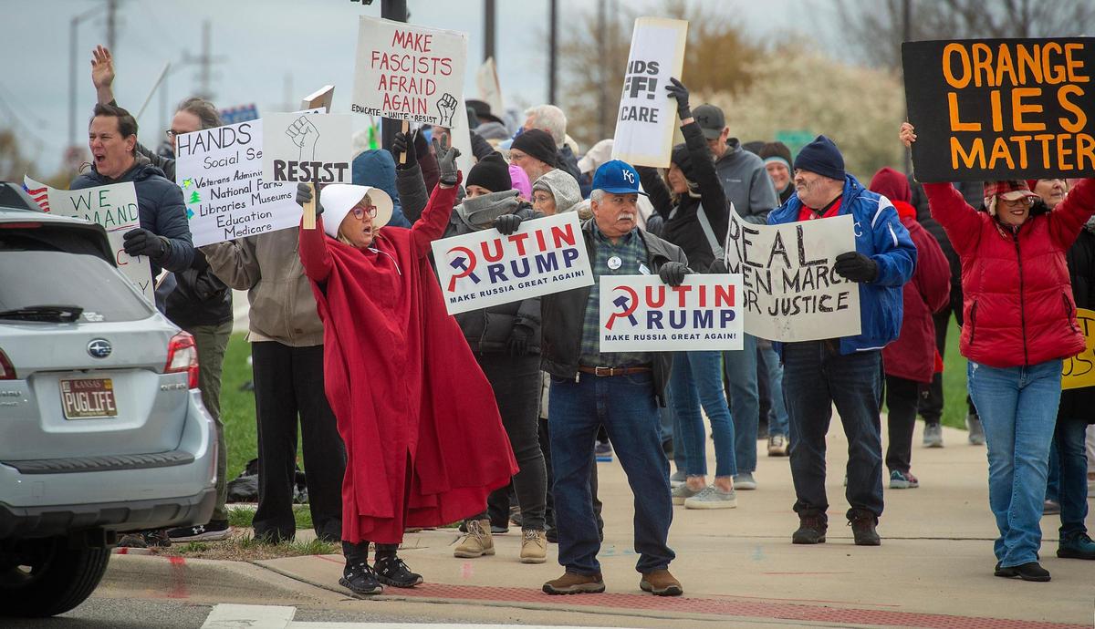 Pro-democracy demonstrators gathered near West 87th Street and Maurer Road in Lenexa on Saturday, April 5, to protest the policies of the Trump administration. The protest was part of an organized nationwide effort called “Hands off!”