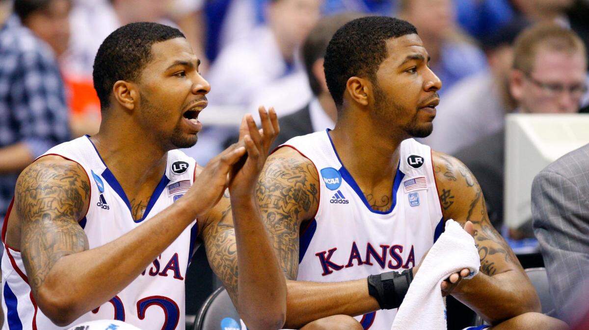 KU players Marcus Morris (22) and Markieff Morris (21) react on the bench during the NCAA Tournament against the Richmond Spiders at the Alamodome in San Antonio on March 25, 2011.