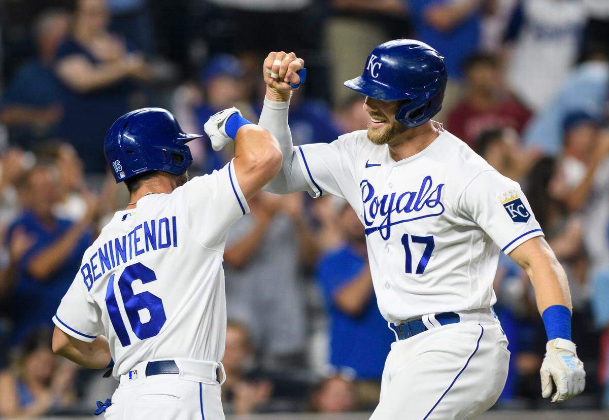 Kansas City Royals’ Hunter Dozier celebrates his two-run home run with teammate Andrew Benintendi during the seventh inning of a baseball game against the Houston Astros Wednesday, Aug. 18, 2021, in Kansas City, Mo. (AP Photo/Reed Hoffmann)