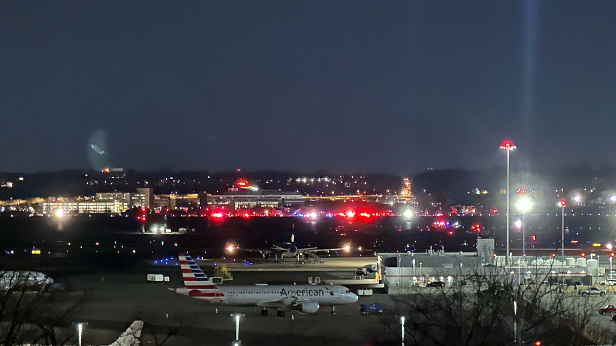 Rescue workers respond at Reagan National Airport Wednesday night after a passenger flight from Wichita to Washington collided with a helicopter and crashed into the Potomac River.