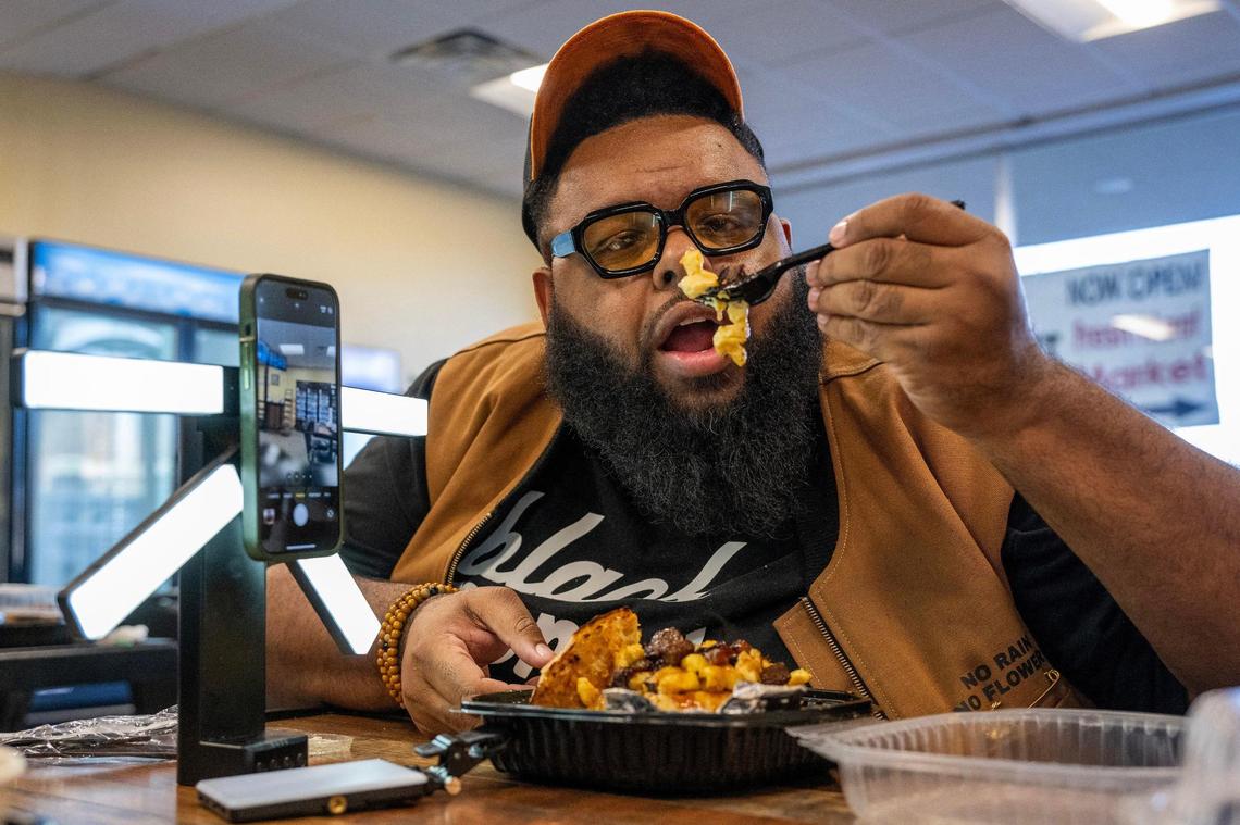 Glenn Robinson, creator of Hood Dude Food Reviews prepares to try the brisket mac and cheese bread bowl at The Upper Cut KC in Liberty.