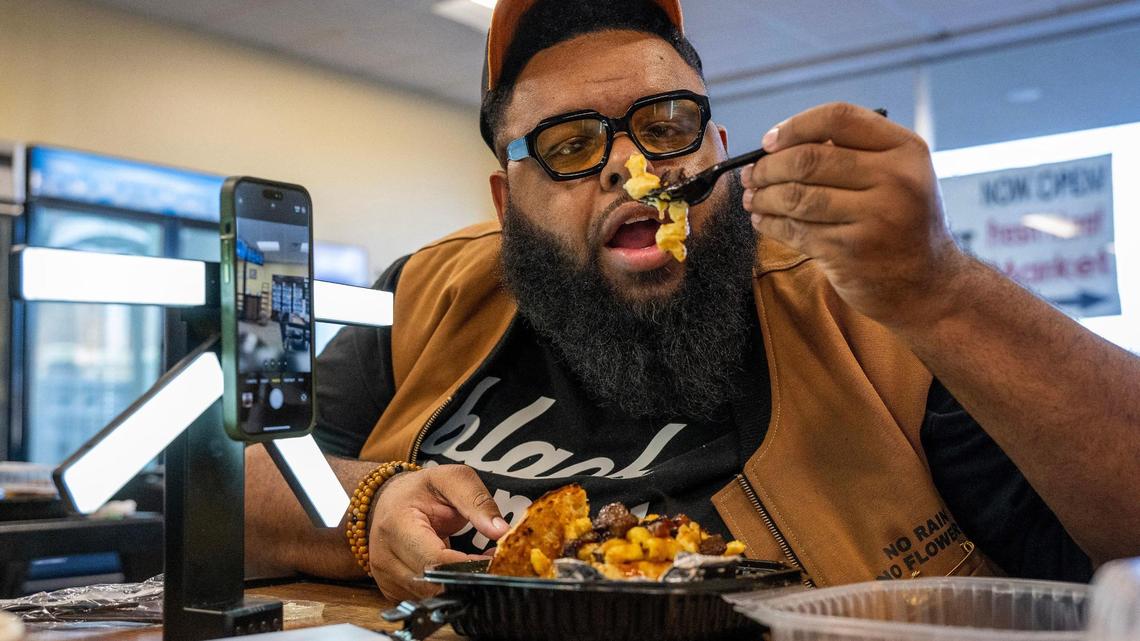 Glenn Robinson, creator of Hood Dude Food Reviews prepares to try the brisket mac and cheese bread bowl at The Upper Cut KC in Liberty.