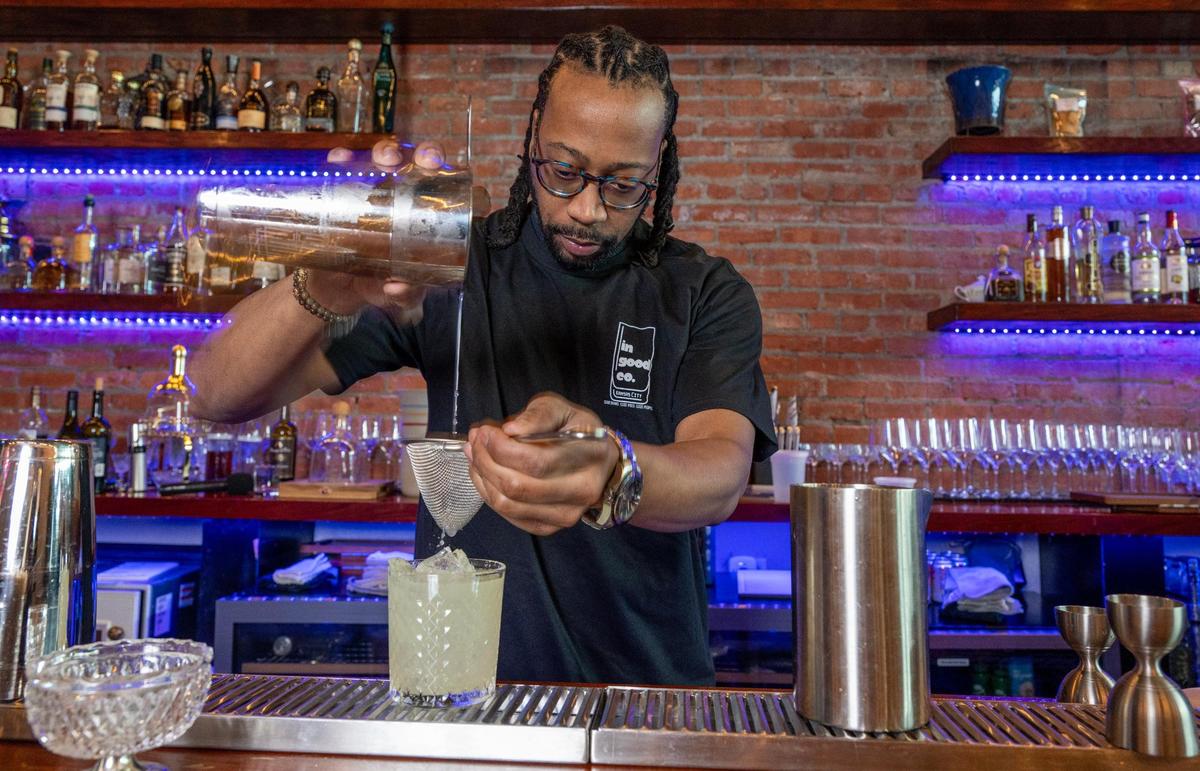 Cedric Ransburg, a co-owner of In Good Company, a new membership cocktail bar, makes a Truman & McGee cocktail at the bar at 1518 McGee St. in Kansas City’s trendy Crossroads Arts District.