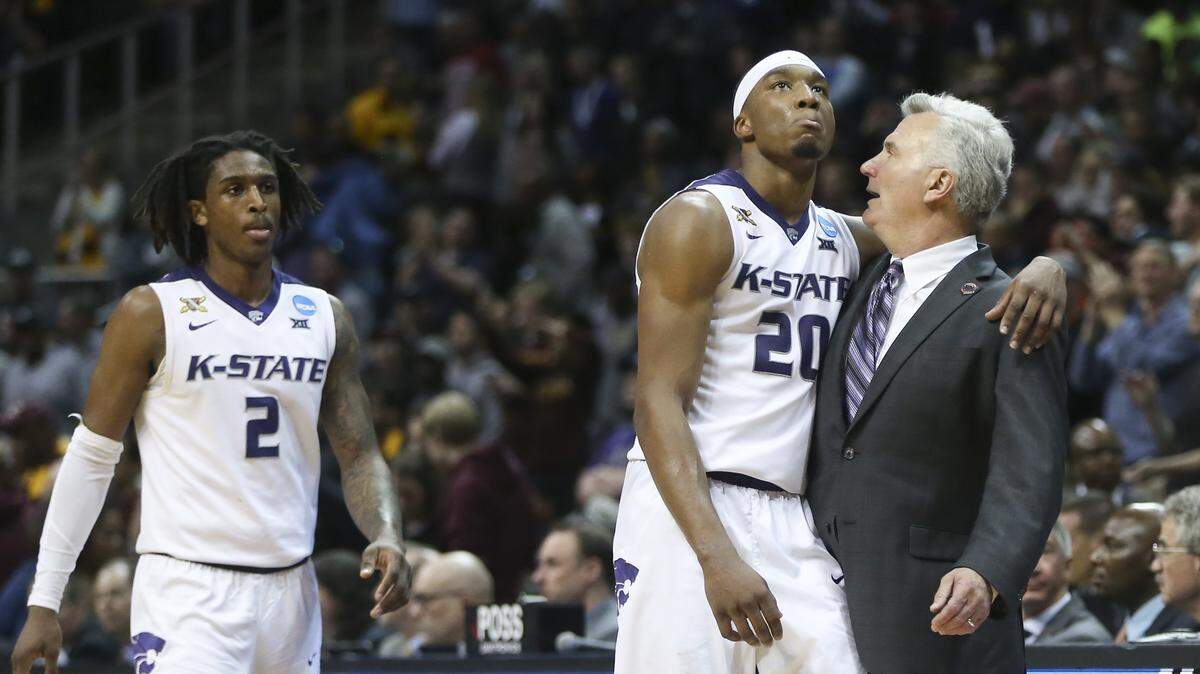 Kansas State coach Bruce Weber hugs forward Xavier Sneed as the Wildcats check out of the game against Loyola-Chicago Saturday night in Atlanta.