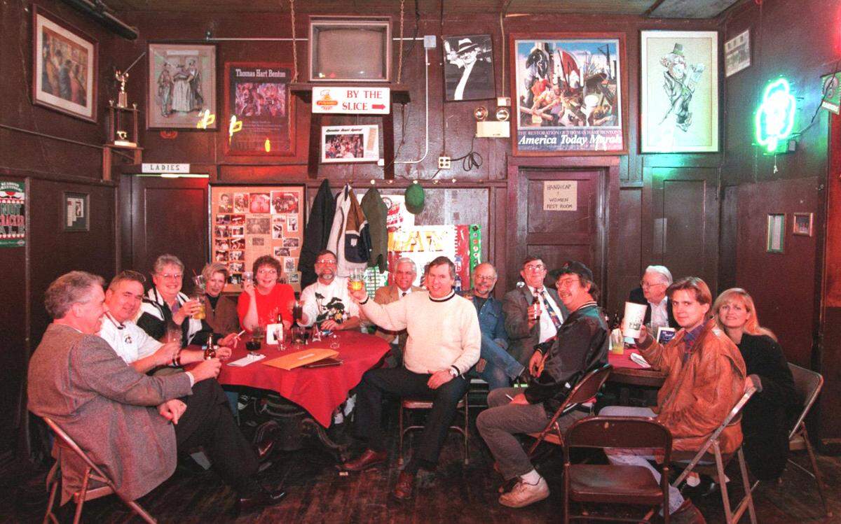 A table of longtime regulars raising their glasses in 1997, Kelly’s 50th year. 