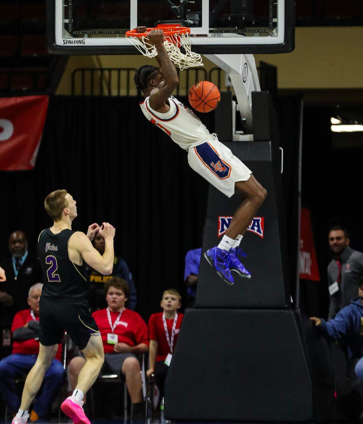 Langston’s Cortez Mosley slams home the game-sealing dunk in Monday night’s NAIA tournament semifinal against the College of Idaho at Municipal Auditorium. The Lions outlasted the Yotes 58-52 to advance to Tuesday’s final against Freed-Hardeman.