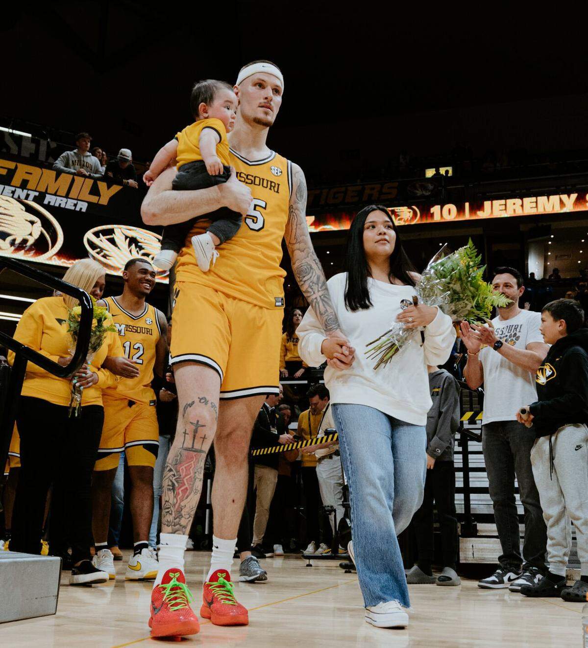 Mizzou’s Jacob Crews and his wife, Karmen, walk into Mizzou Arena before a game against Kentucky holding their son, JJ, on March 8 in Columbia. Karmen was one of the key factors in Jacob’s decision to play for Mizzou.