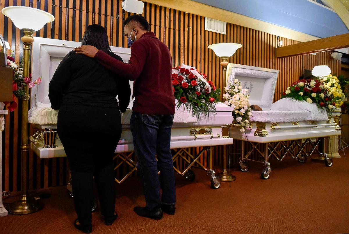 Kenneth and Etta McKenzie were shot and killed in their Raytown home on Jan. 13, 2021. Throughout their lives together, the McKenzies were there for anyone who needed help, according to their children. Daughter Kamille McKenzie, left, and son Kenneth McKenzie Jr. look at their mother during the visitation at Eley & Sons Funeral Chapel Thursday, Jan. 21, 2021. Their father is on the right.