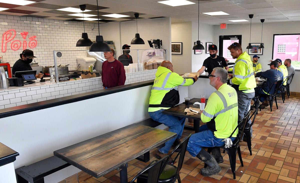 “I knew we would be busy, but not this busy,” said Carlos Mortera, left, chef and owner of Poio Mexican BBQ, which recently opened a Kansas City, Kansas, location. “We survived the pandemic. I think we’re good.”