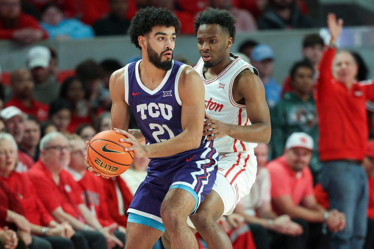 TCU Horned Frogs guard Noah Reynolds (21) controls the ball as Houston Cougars guard L.J. Cryer (4) defends during the first half at Fertitta Center on Jan. 6, 2025.