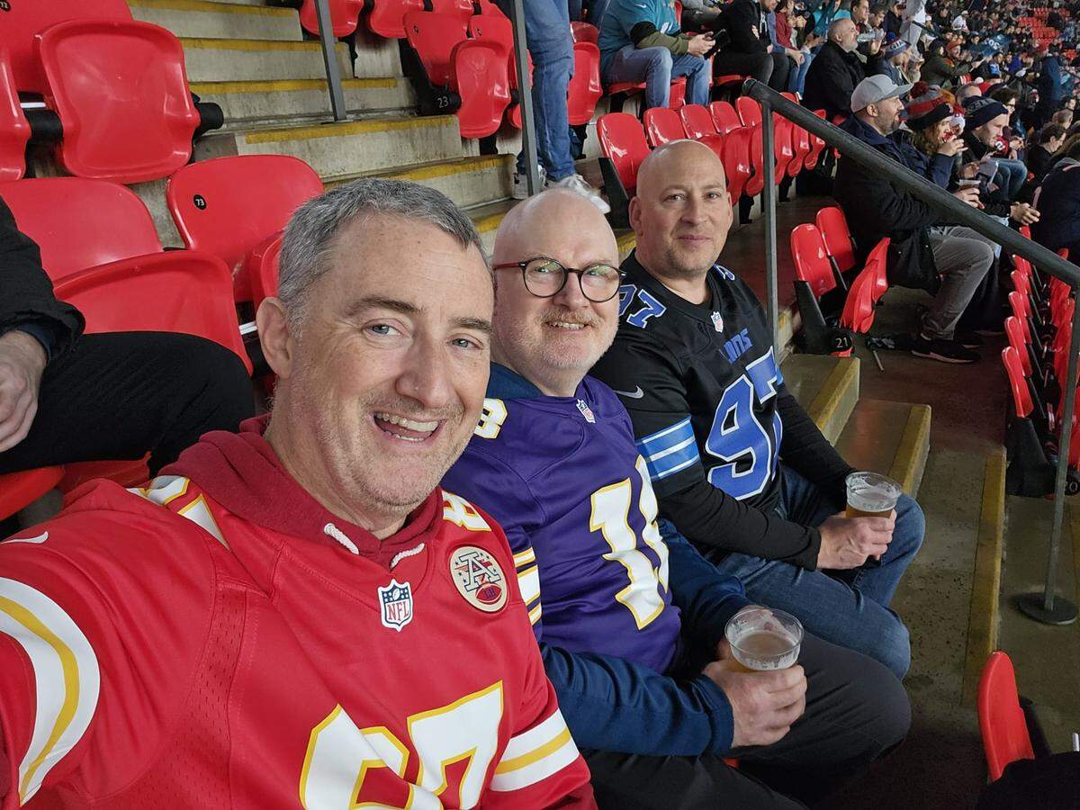 Chiefs fan Keith Graham of Bristol, England in his Travis Kelce jersey in October at London’s Wembley Stadium at a game between the Jacksonville Jaguars and New England Patriots. His brother, Dave, in Minnesota Vikings gear and friend, Matt, in Detroit Lions.