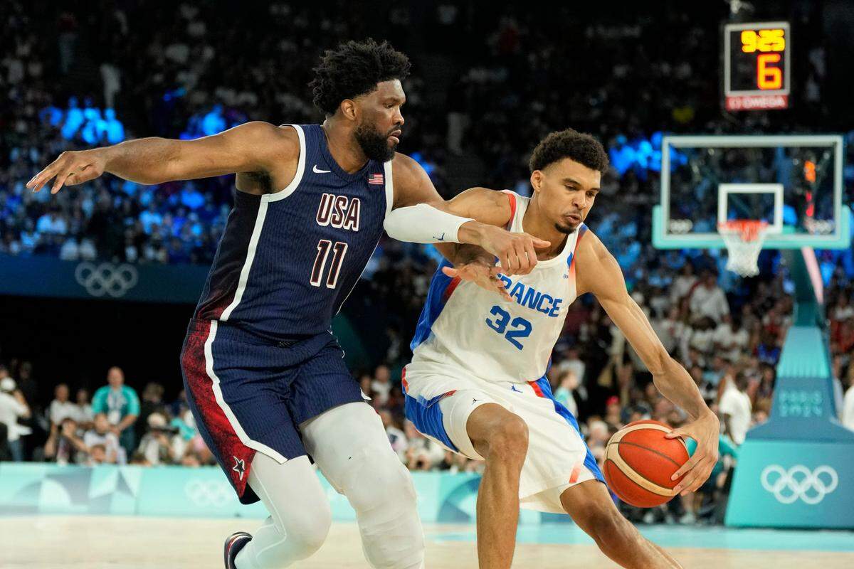 France power forward Victor Wembanyama (32) controls the ball against United States center Joel Embiid (11) in the second half in the men’s basketball gold medal game during the Paris 2024 Olympic Summer Games at Accor Arena on Aug. 10, 2024.