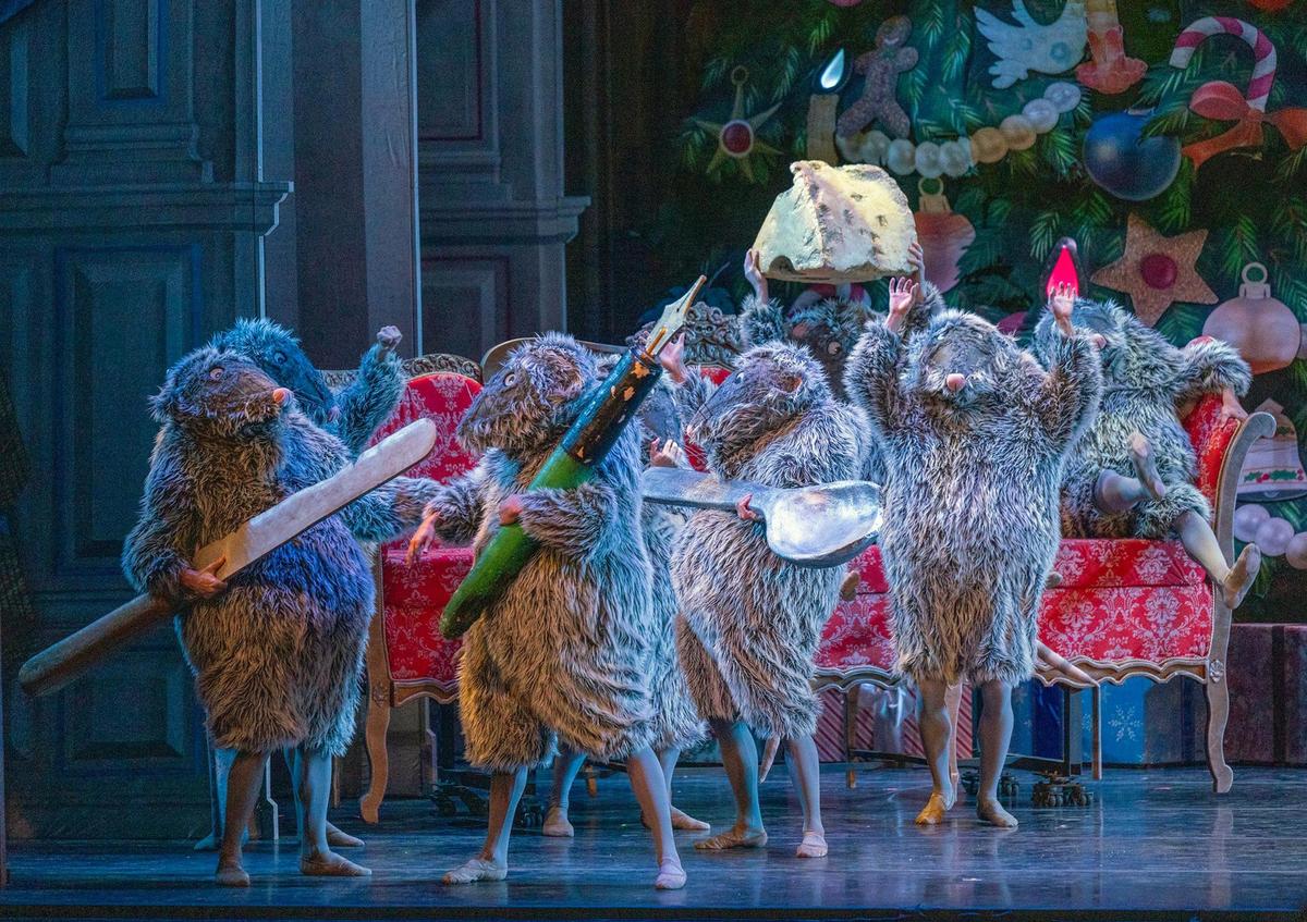 Oversized props carried by dancers in mice costumes are part of the “Battle Scene” in the “The Nutcracker.”