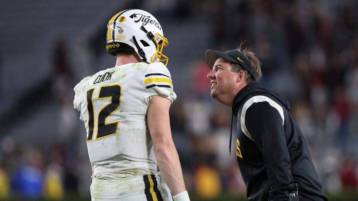 Missouri coach Eliah Drinkwitz, right, talks to quarterback Brady Cook during the second half of Saturday’s game at South Carolina. MU beat the Gamecocks 23-10.