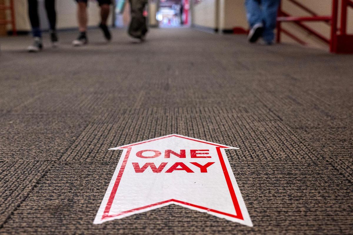 A one-way arrow sign is seen on the floor of a hallway at Park Hill High School on Tuesday, March 18, 2025, in Kansas City.