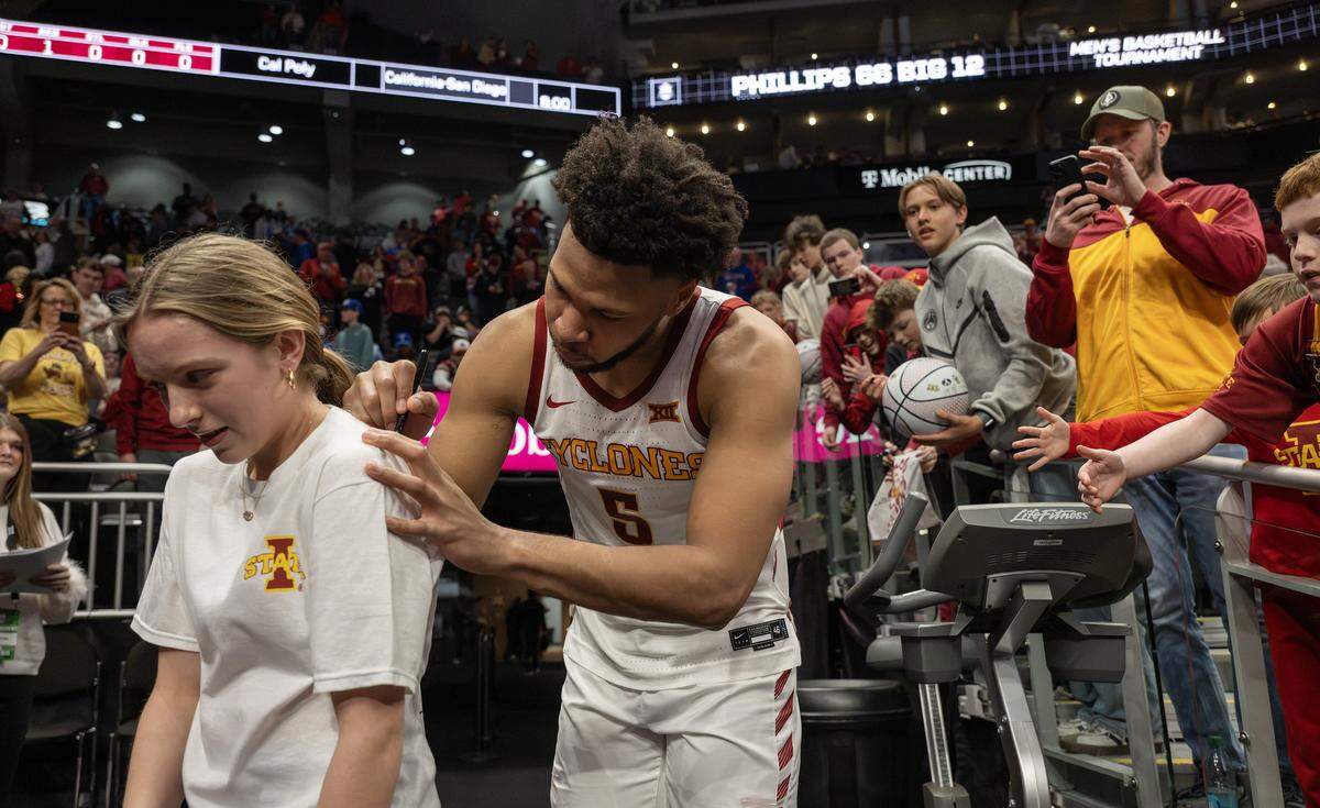 Iowa State forward Joshua Jefferson (5) autographs a fan's T-shirt after Iowa State defeated Arizona State 91-42 in a Big 12 men's basketball tournament game at T-Mobile Center on Wednesday, March 11, 2026, in Kansas City.