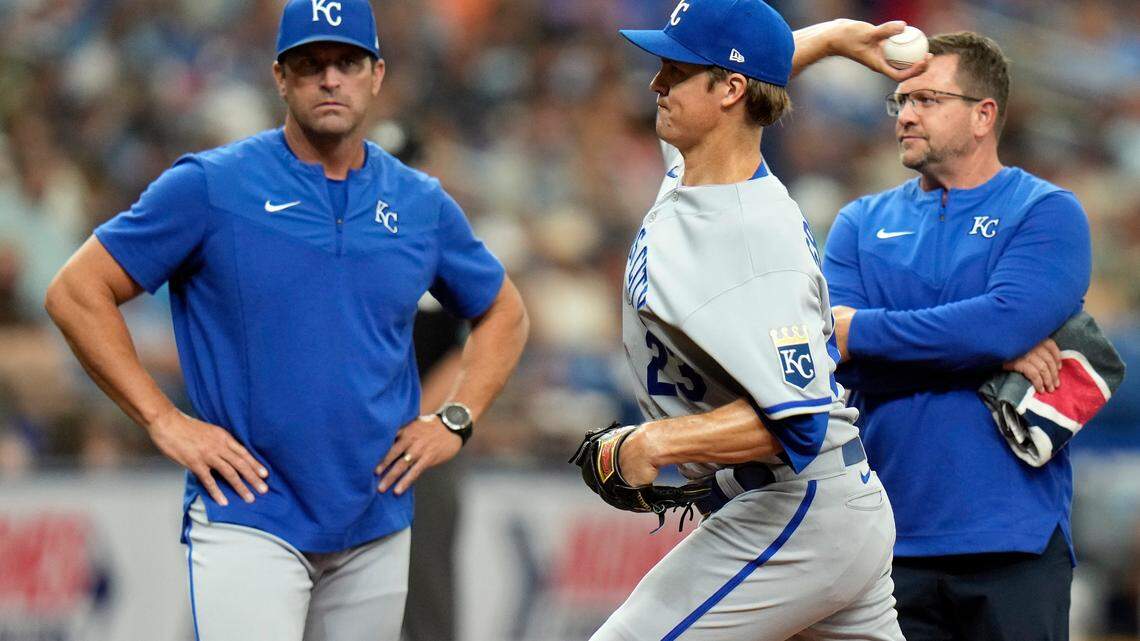 Kansas City Royals manager Mike Matheny, left, watches as starting pitcher Zack Greinke throws a warm up pitch after feeling discomfort in his wrist during the fourth inning of a baseball game against the Tampa Bay Rays Sunday, Aug. 21, 2022, in St. Petersburg, Fla. Greinke stayed on the game. (AP Photo/Chris O’Meara)