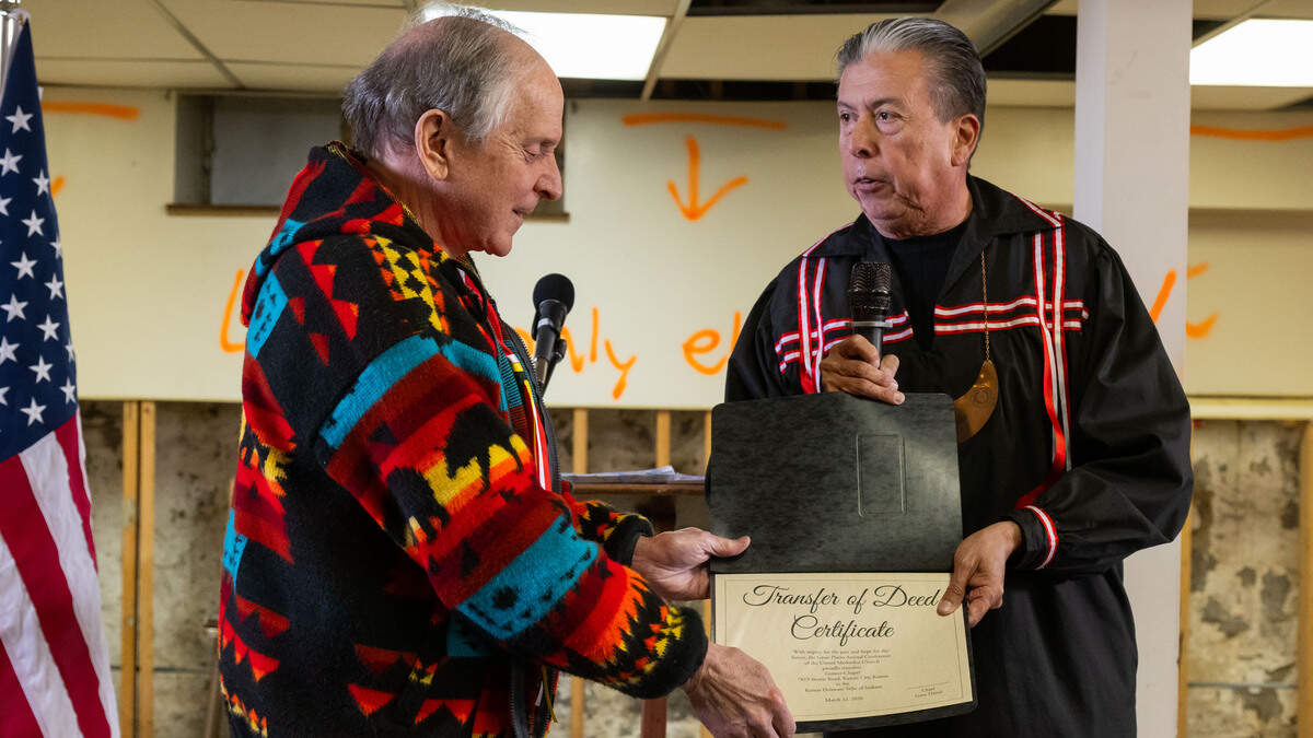 Bishop David Wilson presents the transfer of deed certificate to Chief David Lynn of the Kansas Delaware Tribe of Indians, in the basement of Grinter Chapel during a ceremony on Thursday, March 12, 2026, in Kansas City. The deed to the former church property was given back to the Kansas Delaware Tribe of Indians, Inc.