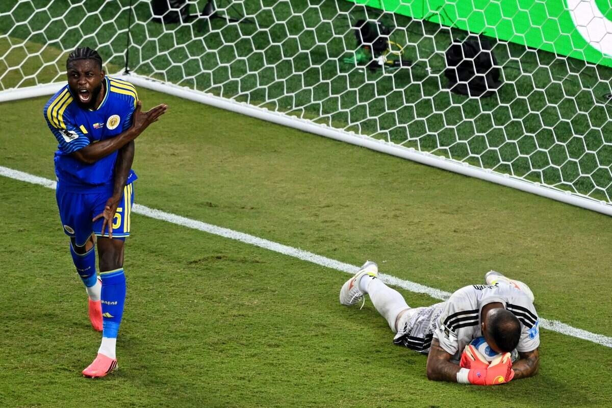 Curaçao defender Sherel Floranus (5) yells at his teammates after Curaçao goalkeeper Eloy Room (1) stops a Ecuador goal attempt in the second half of the Ecuador vs. Curaçao FIFA World Cup group-stage soccer match at Kansas City (Arrowhead) Stadium in Kansas City on Saturday, June 20, 2026.