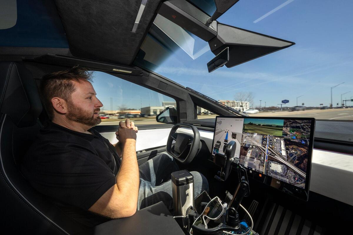 No hands: Jay O’Brien of Liberty, Mo., sits in the driver’s seat of his Tesla Cybertruck as it navigates the streets on autopilot.
