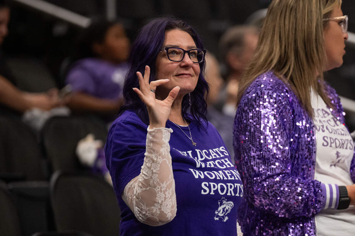 A Kansas State fan flashes the Powercat sign during the second half of the Wildcats’ first-round game vs. the Cincinnati Bearcats in the Big 12 Women’s Basketball Tournament at T-Mobile Center.