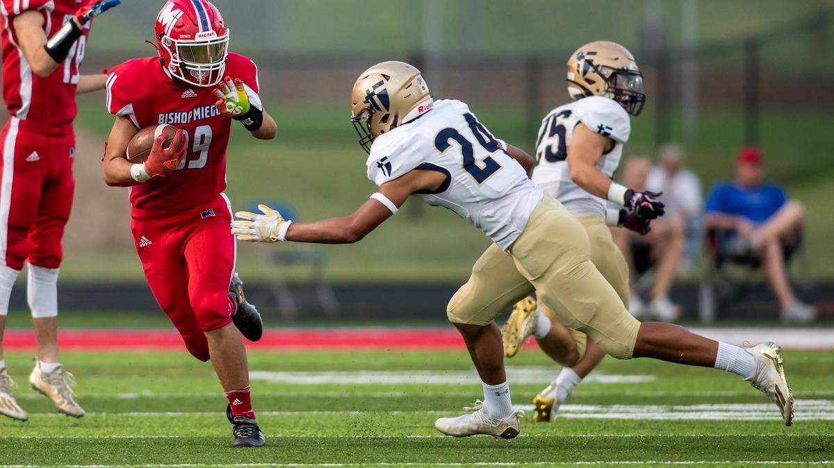 Bishop Miege Junior Degean Jensen (89) attempts to avoid the tackle of St. Thomas Aquinas Sophomore Dillon Marshall (24) during the game between Bishop Miege and St. Thomas Aquinas on September 17, 2021 at Bishop Miege High School in Roeland Park, KS. (Nick Tre. Smith/ Special to the Star)