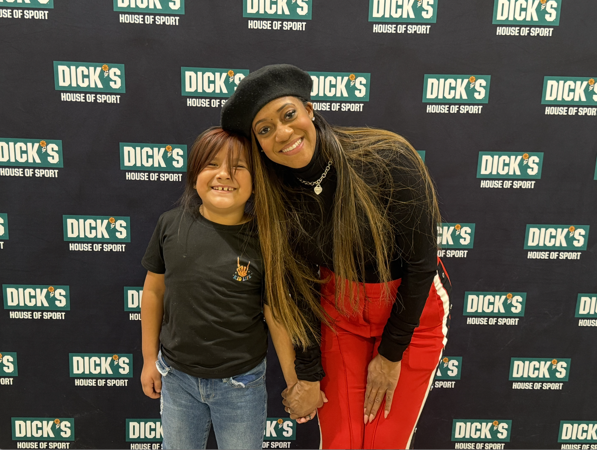 Elaina Paige Thomas of The Next Paige Agency and Worthy 1’s foundation shares a moment with one of the children at the holiday experience.