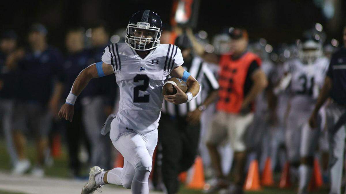 Aiden Hinkle races down the sideline for a 43-yard touchdown during Oak Park’s 35-14 win at Platte County on Friday night.
