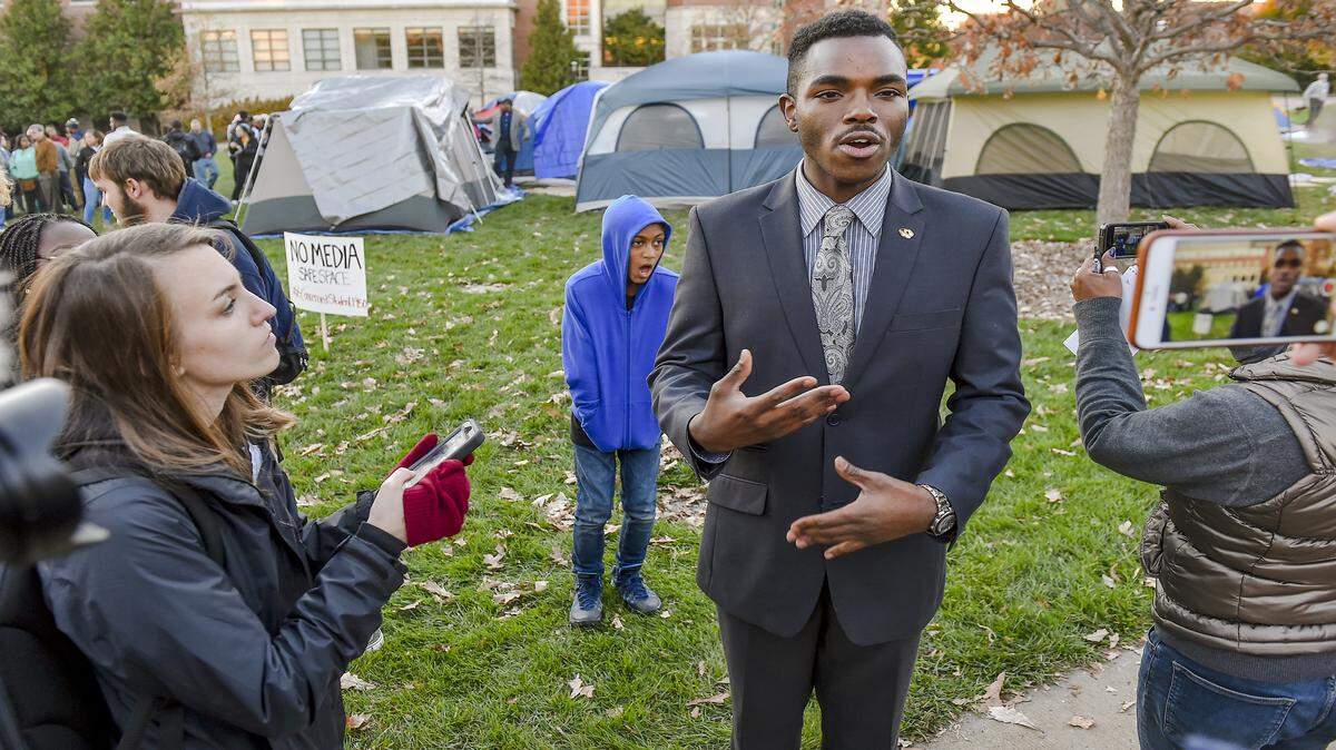 Payton Head, the president of the Missouri Students Association, talked with reporters Sunday as   demonstrations continued at Traditions Plaza on the Columbia campus. Protesters are demanding that Tim Wolfe, the president of the university system, step down or be fired for his actions amid a series of racial incidents on campus.