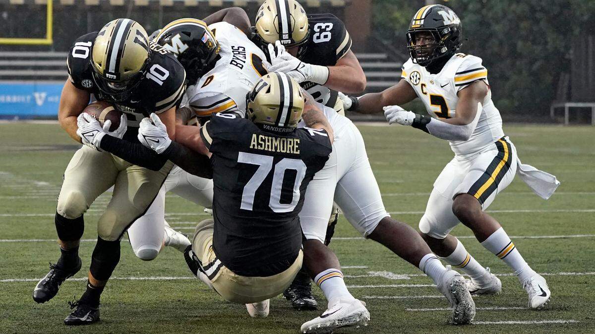 Vanderbilt tight end Gavin Schoenwald (10) gets past Missouri defensive lineman Akial Byers (0) as Schoenwald scores a touchdown in the second half of an NCAA college football game Saturday, Oct. 30, 2021, in Nashville, Tenn. (AP Photo/Mark Humphrey)