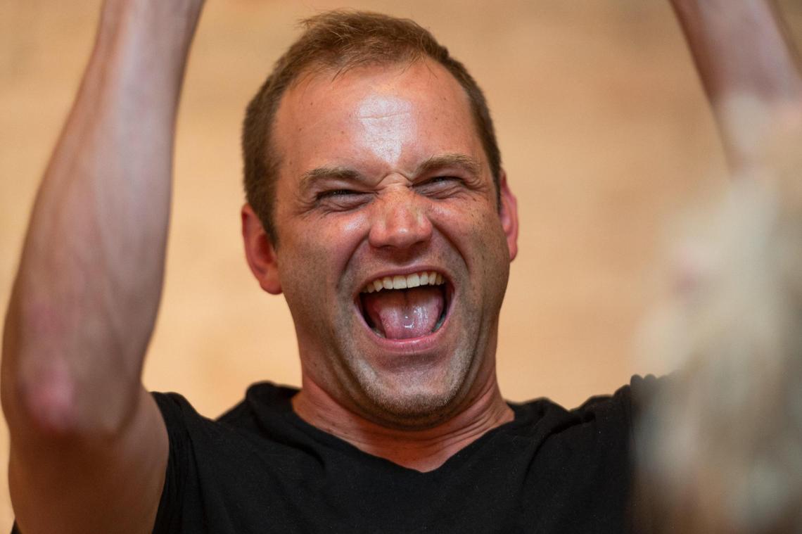 Shawn Lillig laughs during a laughing role play performance.