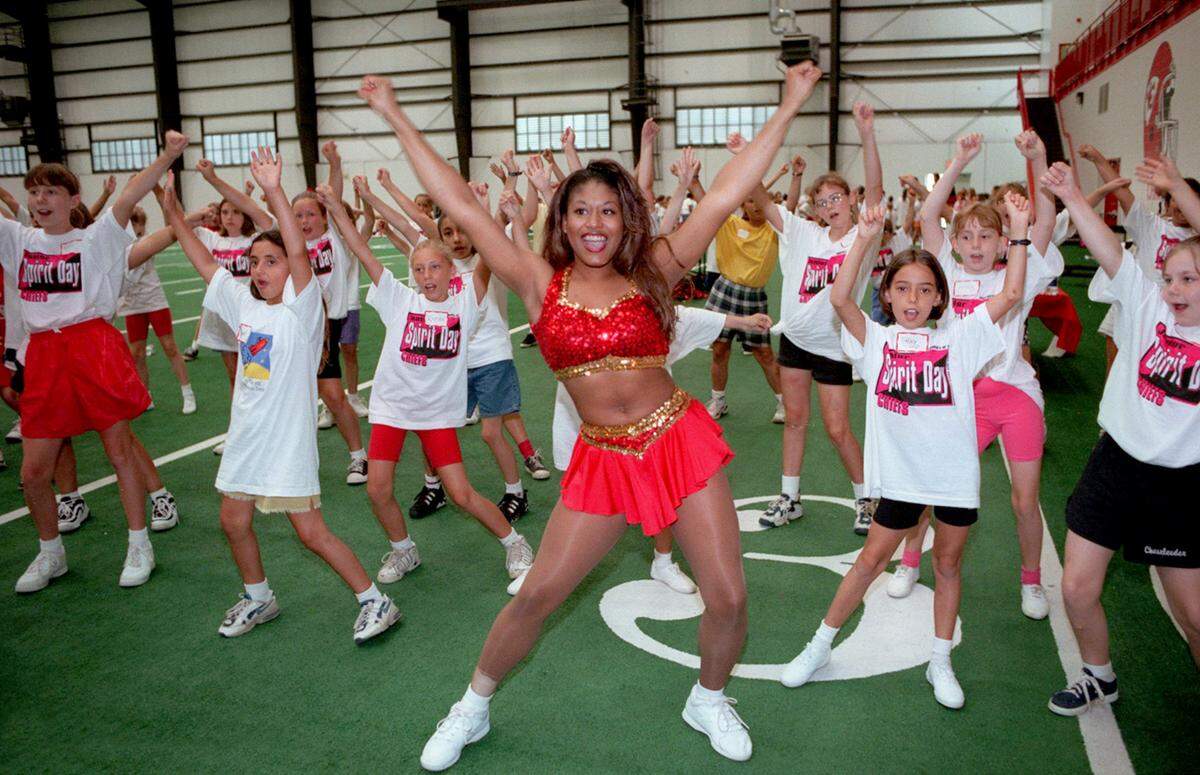 Kansas City Chiefs Cheerleader Angel Block leads girls ages 5-12 at the second cheerleading and dance clinic at the Chiefs’ indoor practice facility at Arrowhead Stadium in 1997.