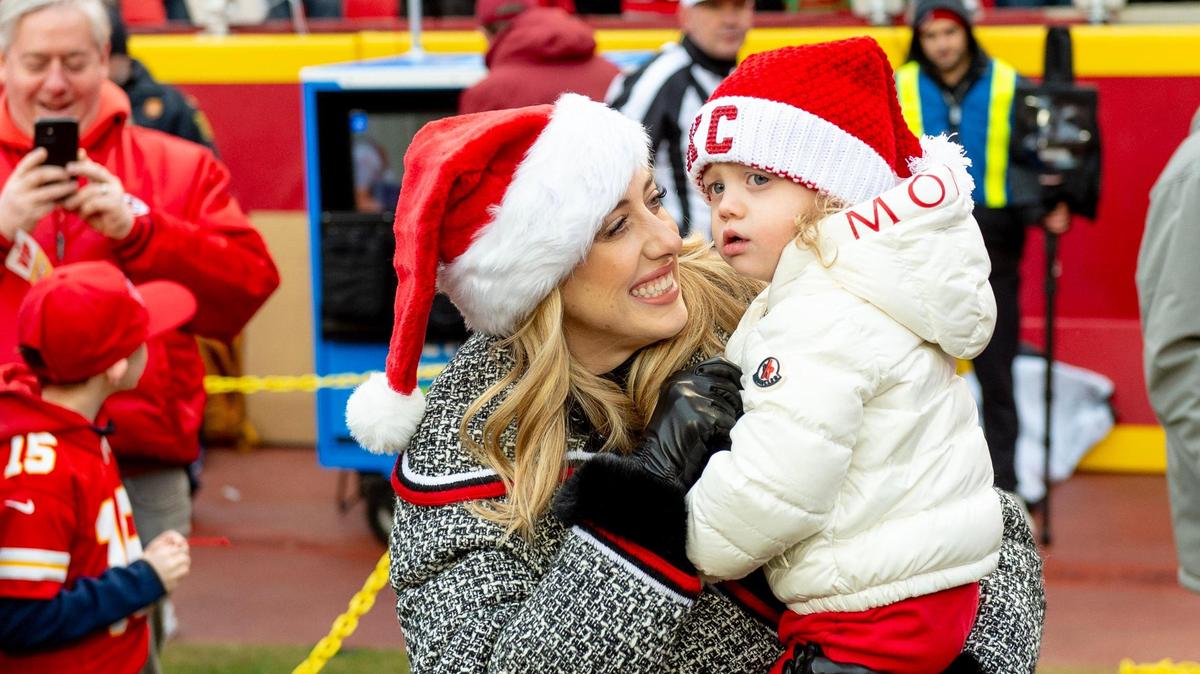 Brittany Mahomes holds her daughter, Sterling, after Patrick Mahomes greeted them ahead of the Chiefs game against the Las Vegas Raiders on Christmas Day at GEHA Field at Arrowhead Stadium.
