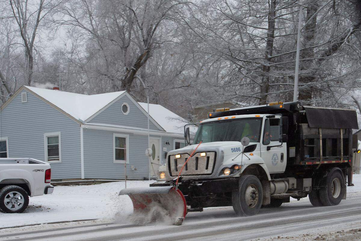 A plow truck clearing the snow and ice off of 75th Street in Prairie Village during a past winter storm.