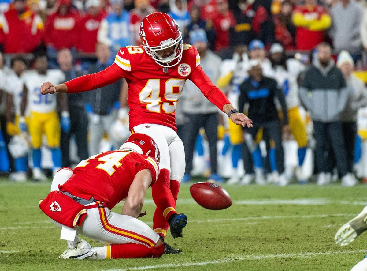 Kansas City Chiefs punter Matt Araiza (14) holds as place kicker Matthew Wright (49) kicks the winning field goal to give the Chiefs a 19-17 win over the Los Angeles Chargers In the second half on Sunday, Dec. 8, 2024, at GEHA Field at Arrowhead Stadium.