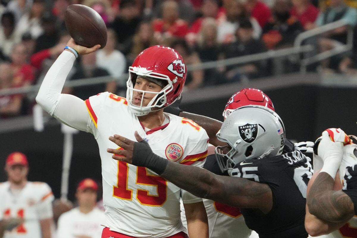 Kansas City Chiefs quarterback Patrick Mahomes (15) throws the ball under pressure from Las Vegas Raiders defensive tackle John Jenkins at Allegiant Stadium Oct 27, 2024 in Paradise, Nevada.
