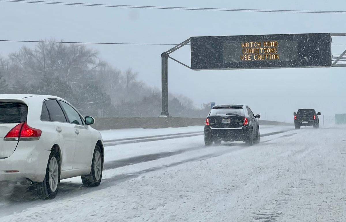 Drivers made their way along a snowpacked I-35 near 95th Street in Johnson County Wednesday morning as snow continued to fall in the area.