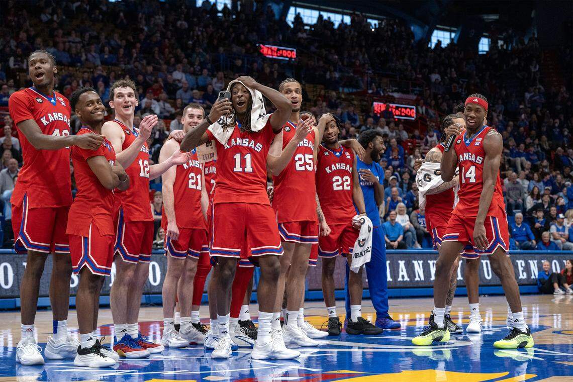 With teammates looking on, Kansas Jayhawks guard Melvin Council Jr. (14), right, gives his speech on Senior Day after Kansas defeated Kansas State, 104-85, at Allen Fieldhouse on Saturday, March 7, 2026, in Lawrence, Kansas.