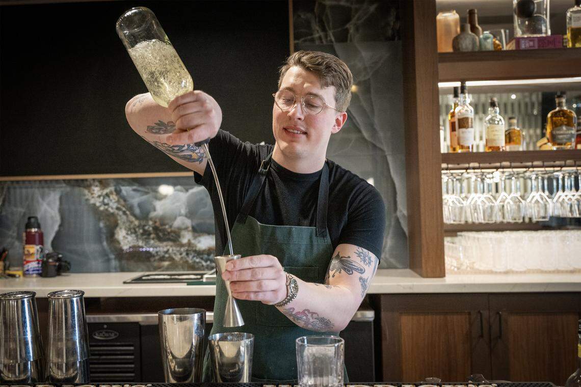 Hunter Hebenstreit, bar manager at Of Course Kitchen & Co., makes a cocktail called Bitter Sweet Symphony, on Tuesday, Feb. 24, 2026, in Overland Park. The cocktail is made of El Trago Tequila, Cocchi Americano, and bitter melon cordial.