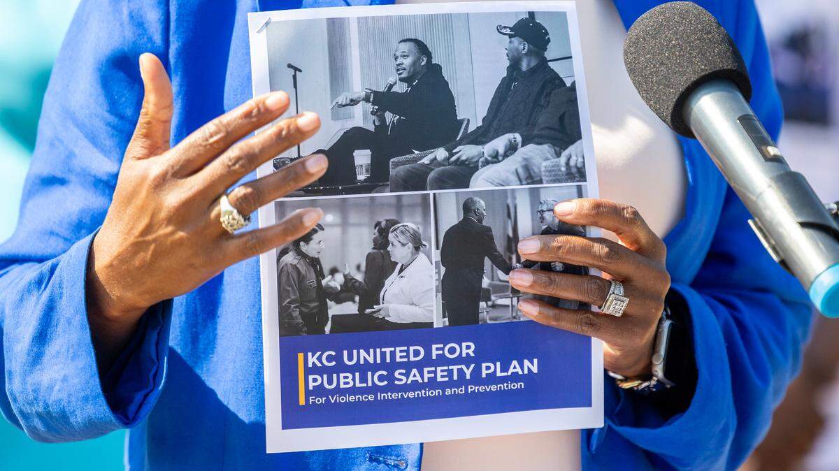 Mayor Pro Tem Ryana Parks-Shaw holds up a summary of a report that suggests ways the community could address crime in Kansas City.
